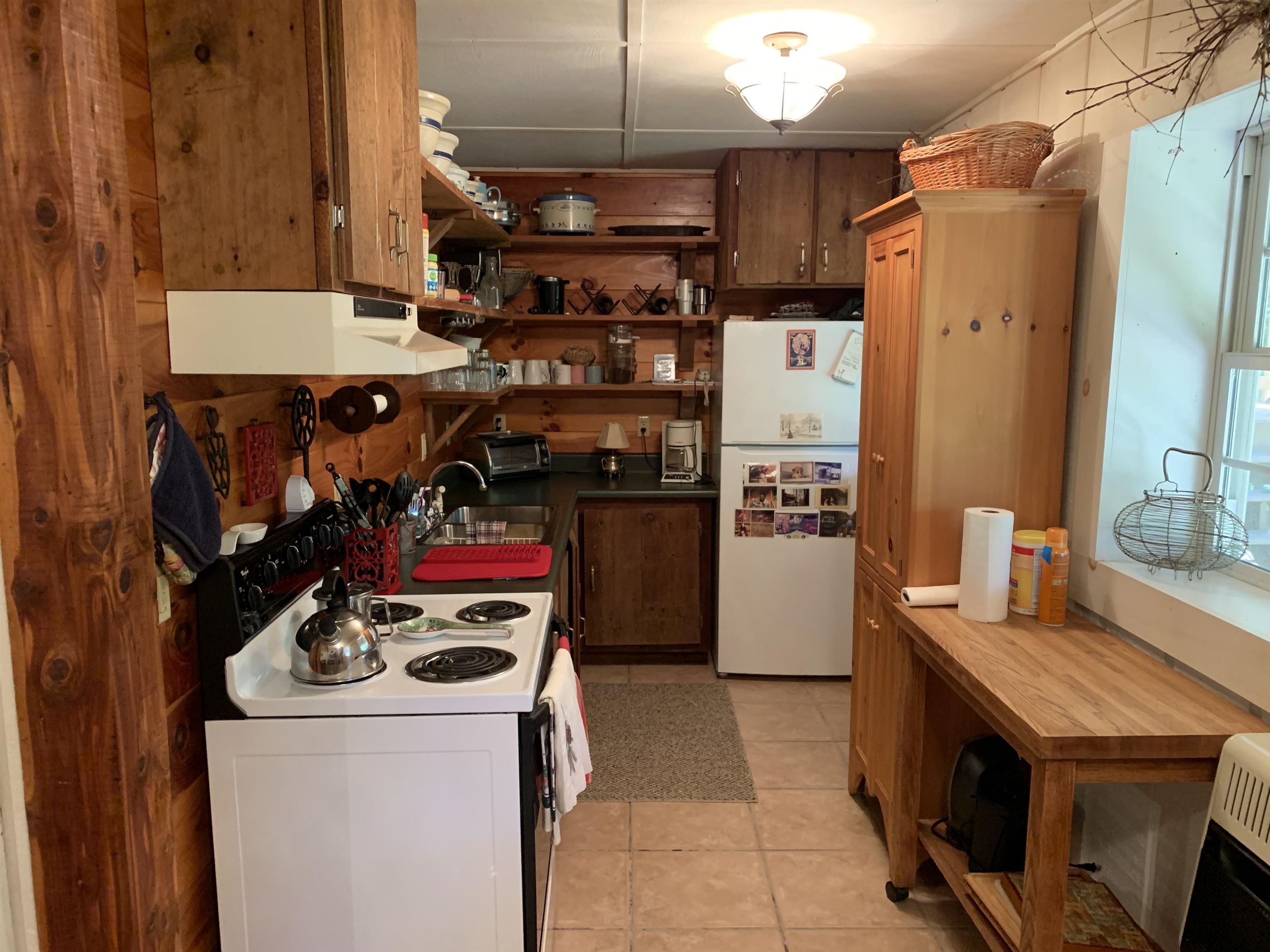 13334 Tower Hill Road Williamsville, VA 24487 - Photo 5 of 9 a kitchen with a stove and a refrigerator