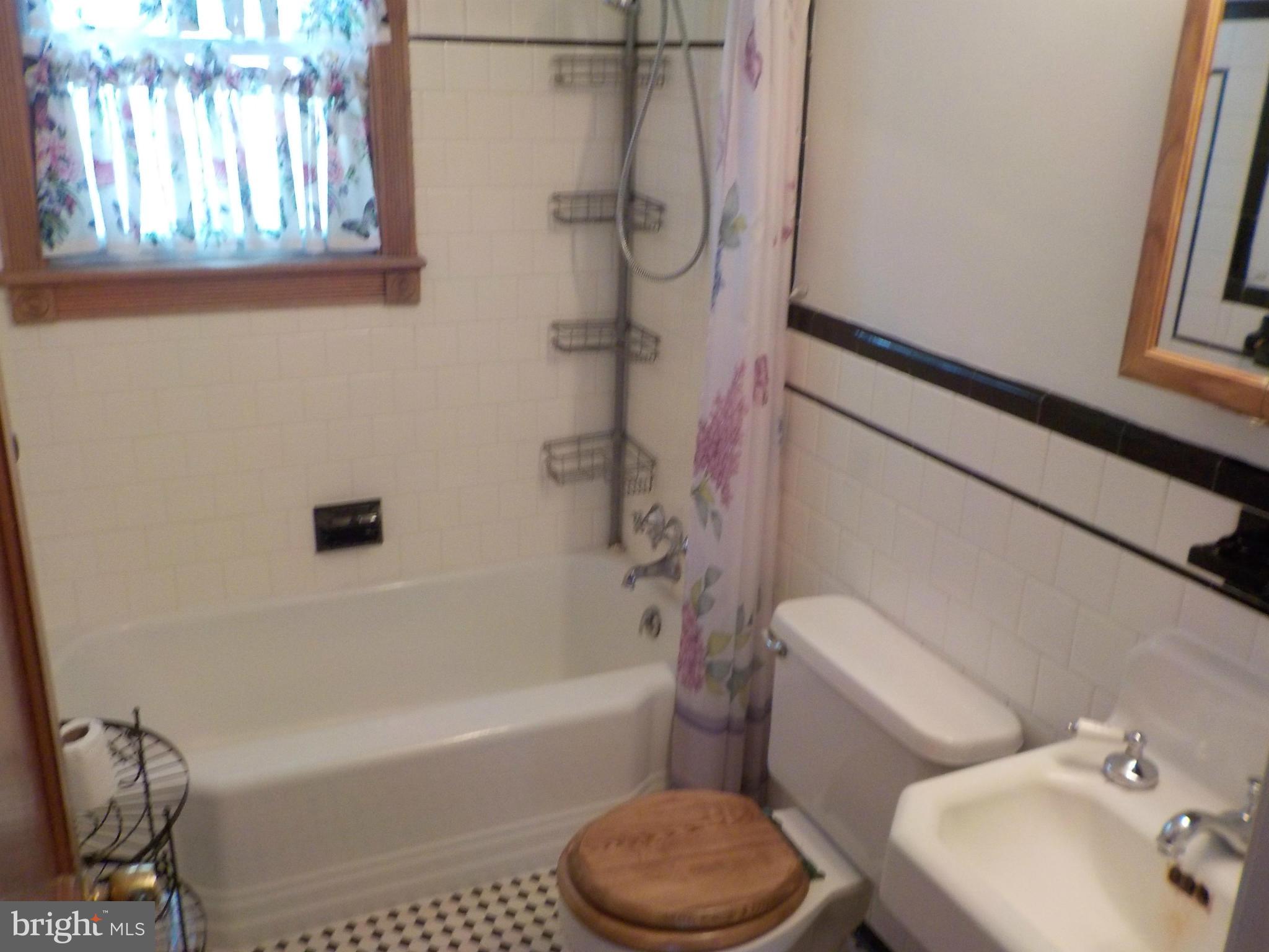 2503 Windsor Road Baltimore, MD 21234 - Photo 22 of 30 a bathroom with a toilet and a bathtub