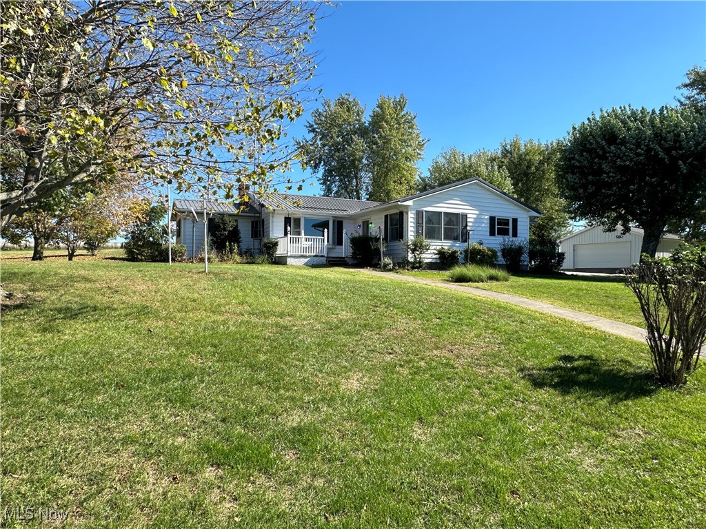 59558 Sandy Ridge Road Barnesville, OH 43713 - Photo 1 of 46 Single story home with a garage, a front lawn, and an outbuilding