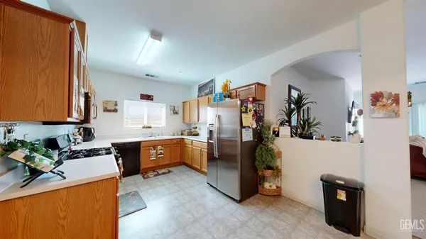 a view of a kitchen with fridge and workspace