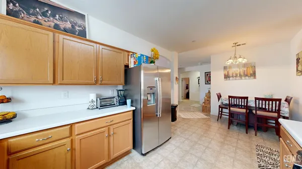 a kitchen with refrigerator and cabinets