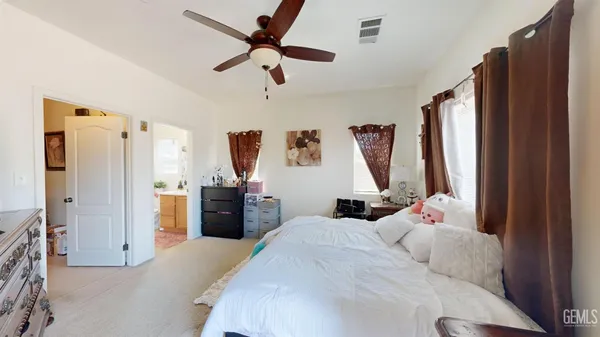 a bedroom with a bed a window and a chandelier