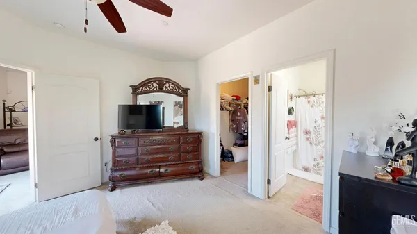 a bedroom with a bed and a dresser