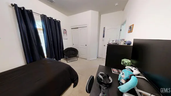 a bedroom with a bed and a large window