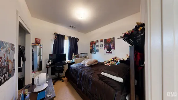 a bed room with a bed mirror and a walk in closet