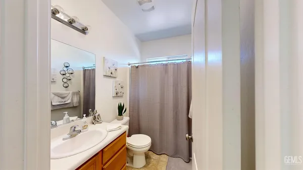 a spacious bathroom with a bathtub sink and mirror