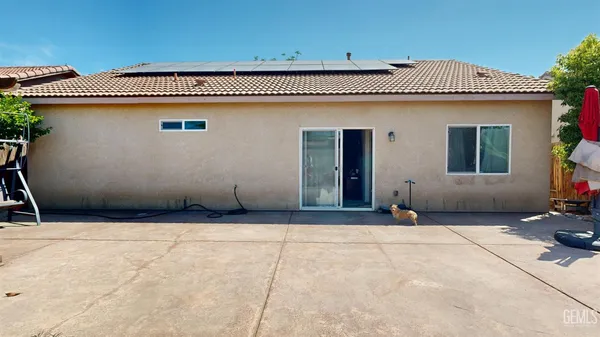 a view of backyard with a table and chairs and potted plants