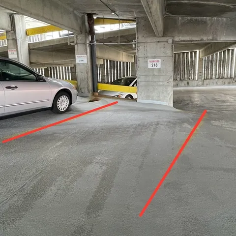 a view of building with car parked