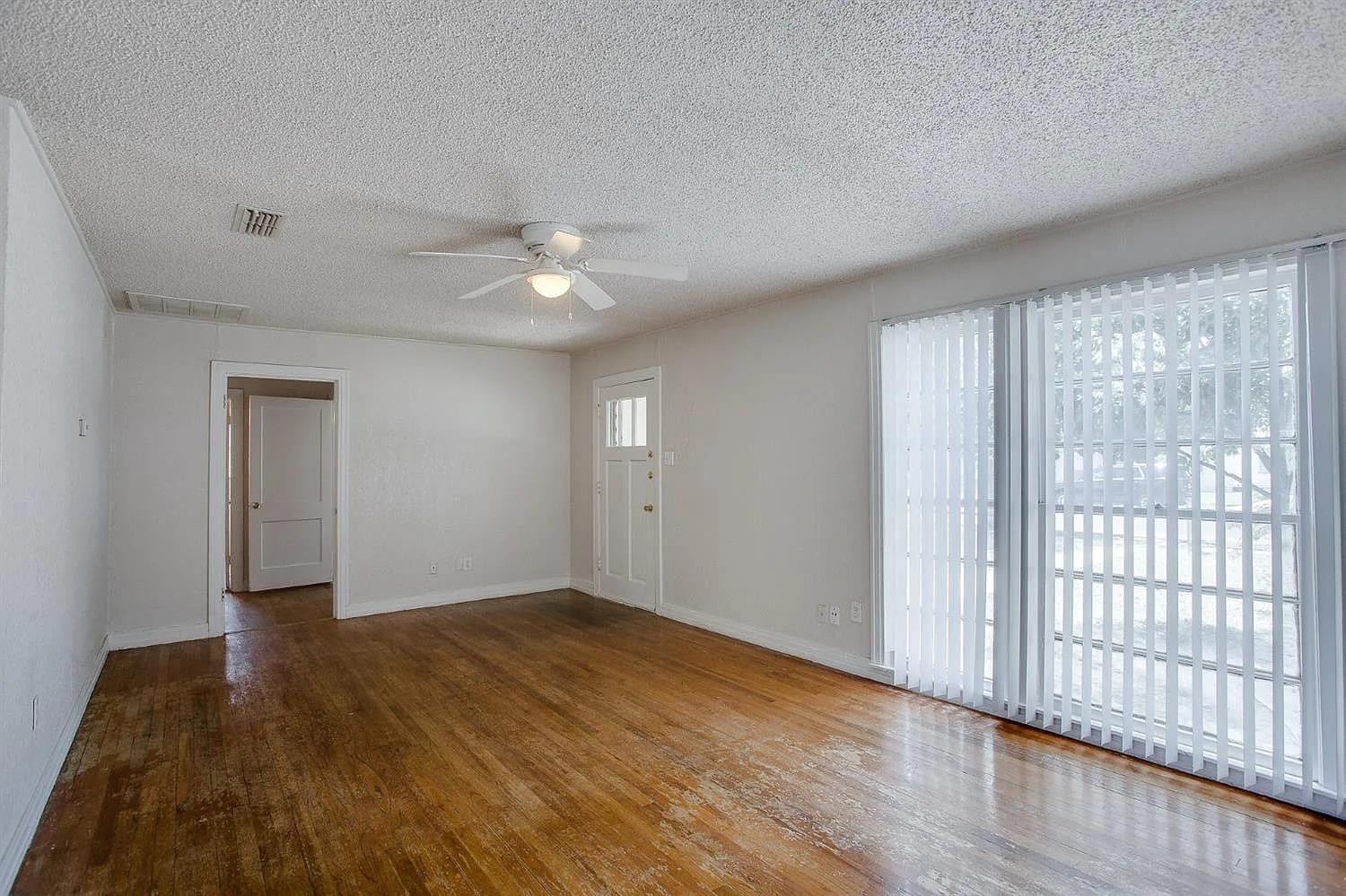 2708 33rd Street Lubbock, TX 79410 - Photo 6 of 12 wooden floor in an empty room with a window