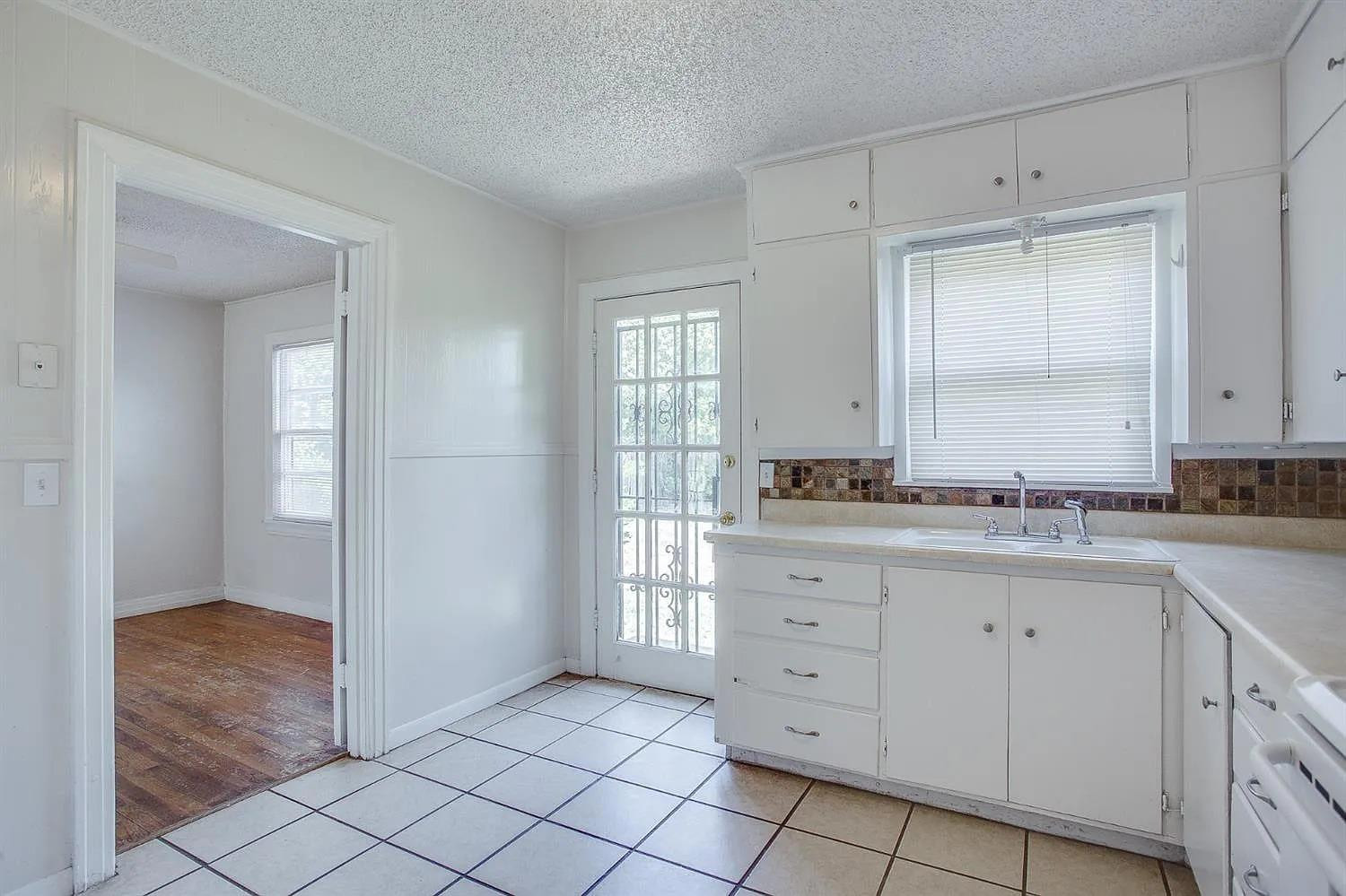 2708 33rd Street Lubbock, TX 79410 - Photo 7 of 12 a spacious bathroom with a granite countertop sink a mirror and a