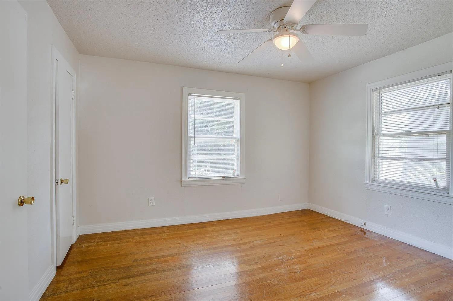 2708 33rd Street Lubbock, TX 79410 - Photo 9 of 12 wooden floor in an empty room with a window