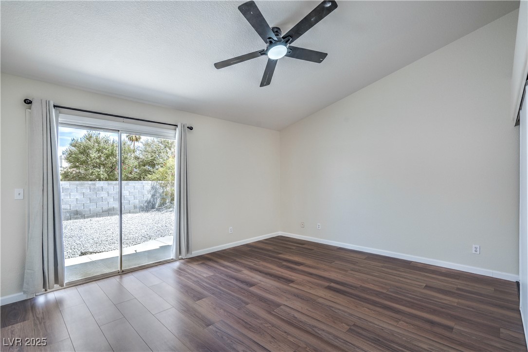 818 Coastal Beach Road Henderson, NV 89002 - Photo 17 of 39 Primary Bedroom featuring vaulted ceiling, dark wood-style flooring, and a ceiling fan