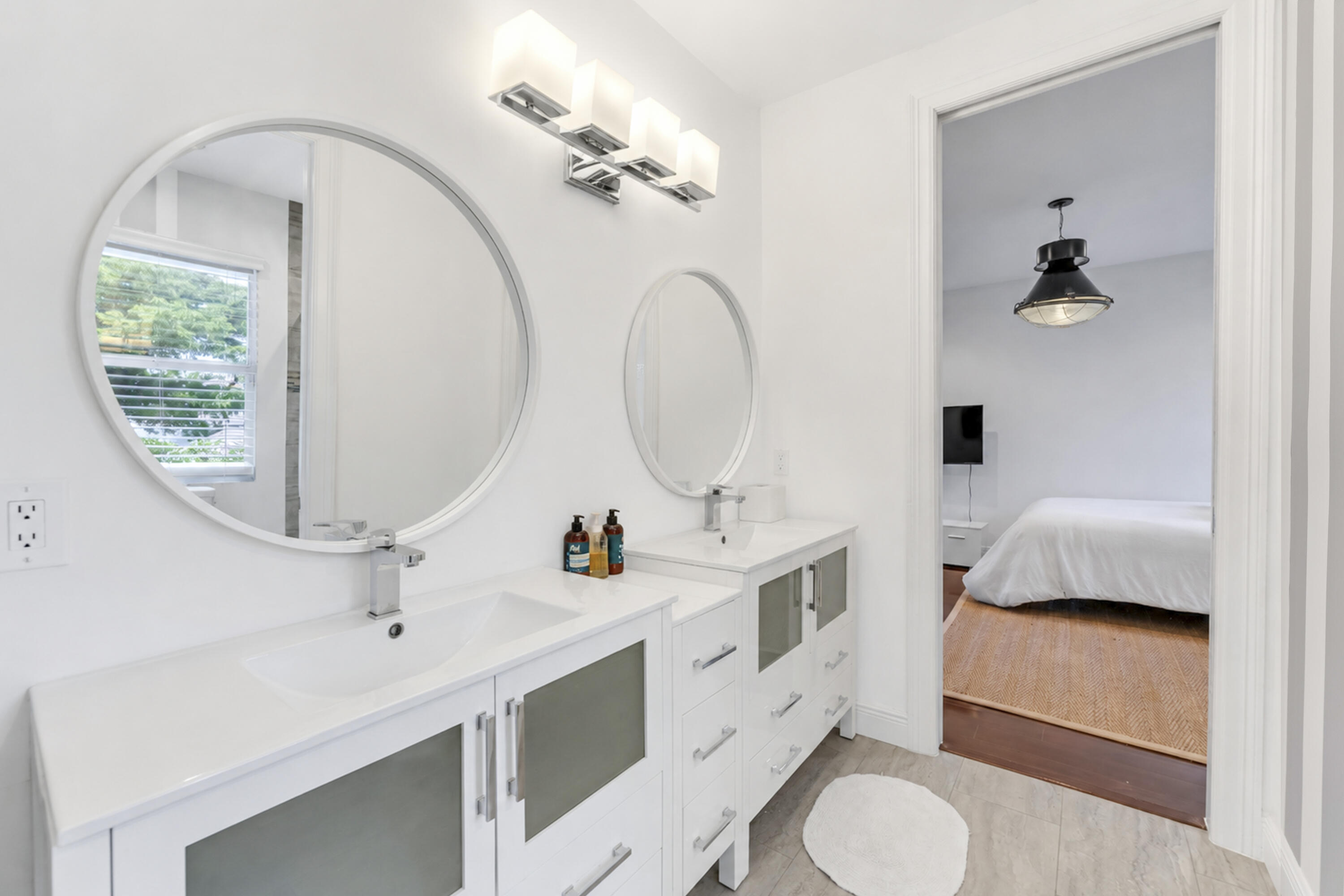 3156 Northwest 61st Street Boca Raton, FL 33496 - Photo 32 of 46 a en suite bathroom with a toilet a sink and mirror