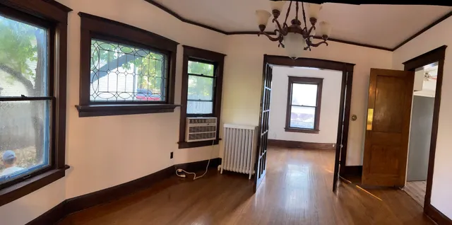 a view of a room with wooden floor and windows