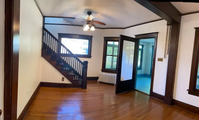 a view of an entryway door with wooden floor and stairs