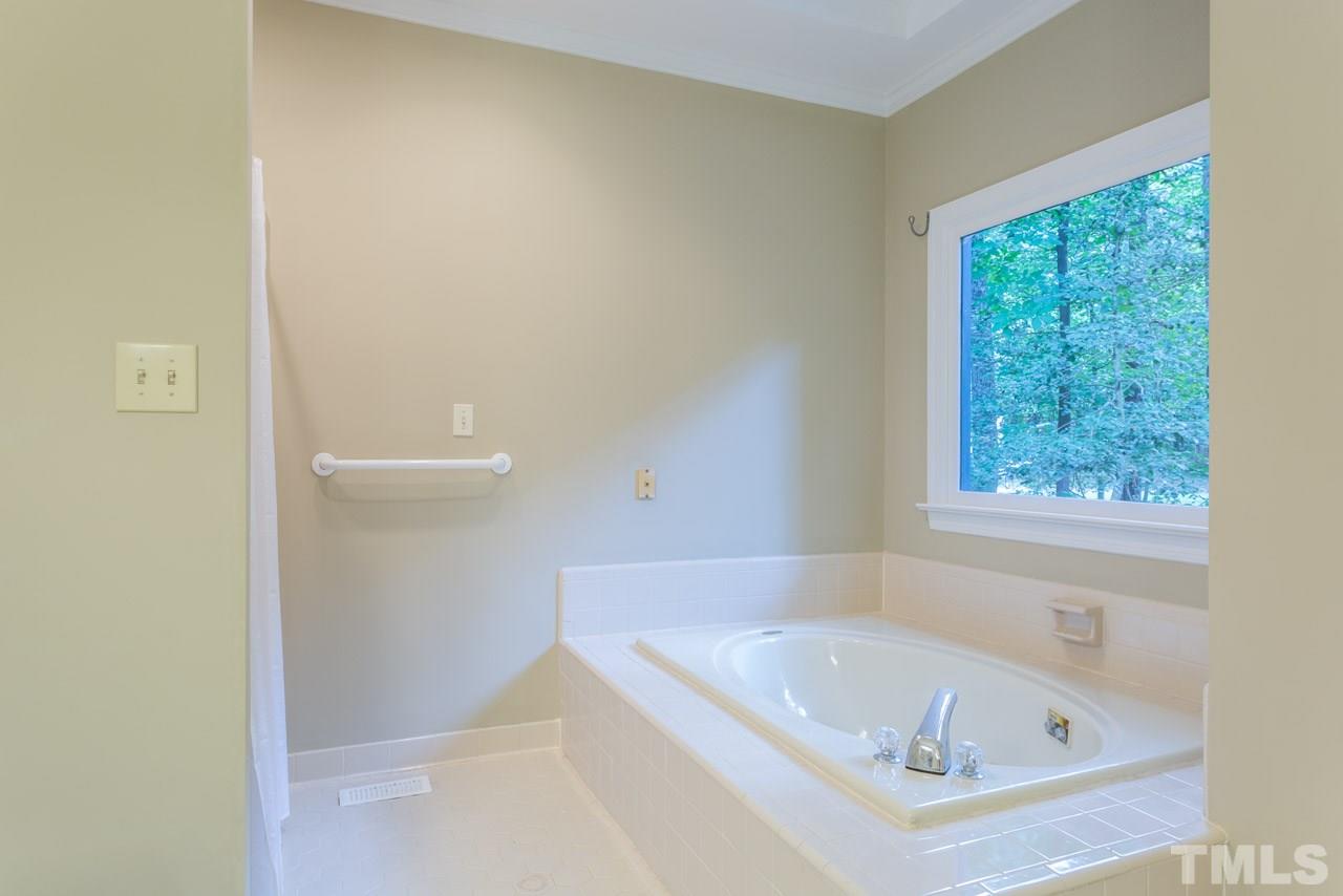 2909 Patrie Place Raleigh, NC 27613 - Photo 14 of 25 a white bath tub sitting next to a window
