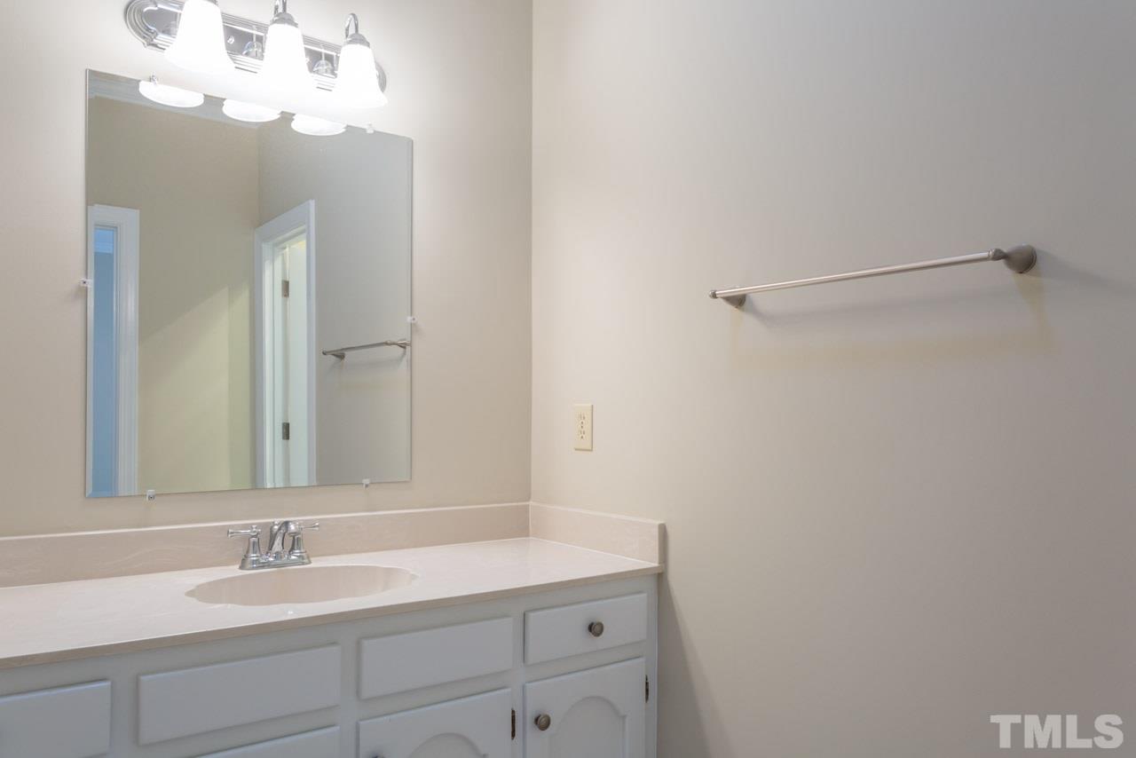 2909 Patrie Place Raleigh, NC 27613 - Photo 18 of 25 a bathroom with a sink and a mirror