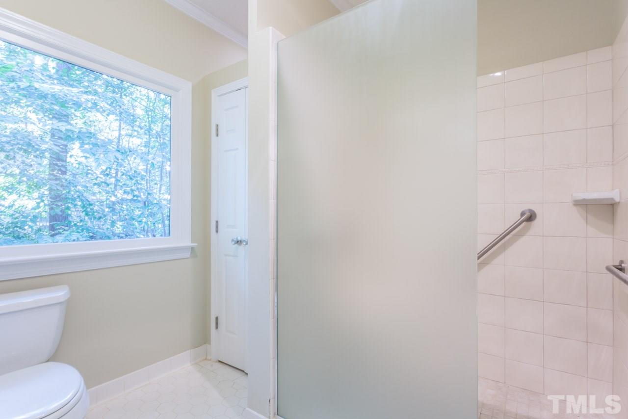 2909 Patrie Place Raleigh, NC 27613 - Photo 19 of 25 a white toilet sitting next to a window