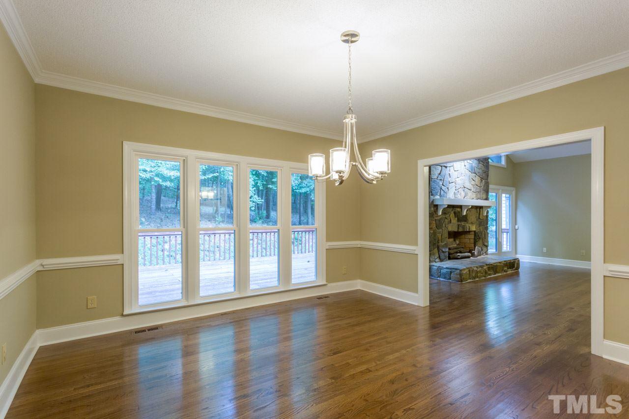 2909 Patrie Place Raleigh, NC 27613 - Photo 6 of 25 a view of a room with wooden floor fireplace and windows