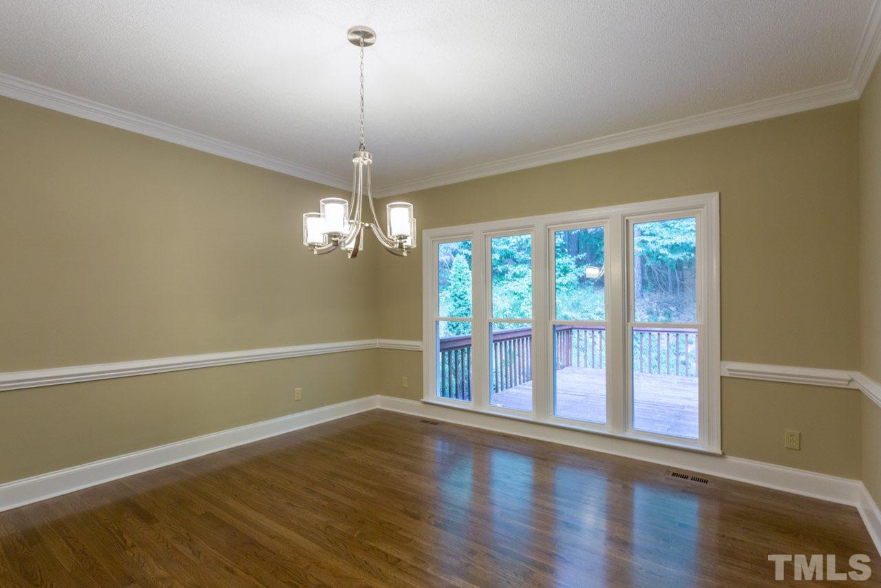 2909 Patrie Place Raleigh, NC 27613 - Photo 7 of 25 a view of an empty room with wooden floor and a window