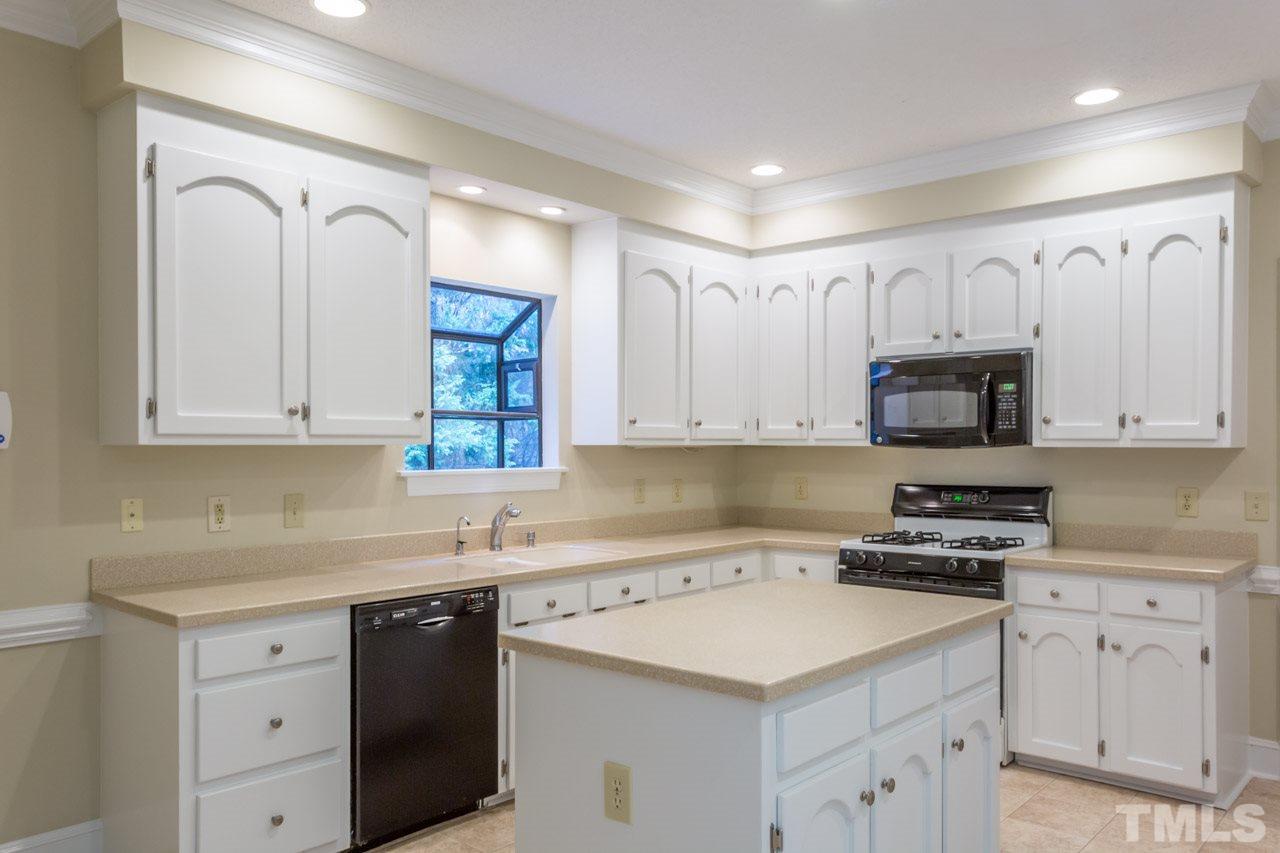 2909 Patrie Place Raleigh, NC 27613 - Photo 10 of 25 a kitchen with cabinets appliances a sink and a window