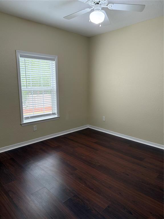 3725 Conroy Road, Unit 2127 Orlando, FL 32839 - Photo 30 of 30 a view of an empty room with wooden floor and a window