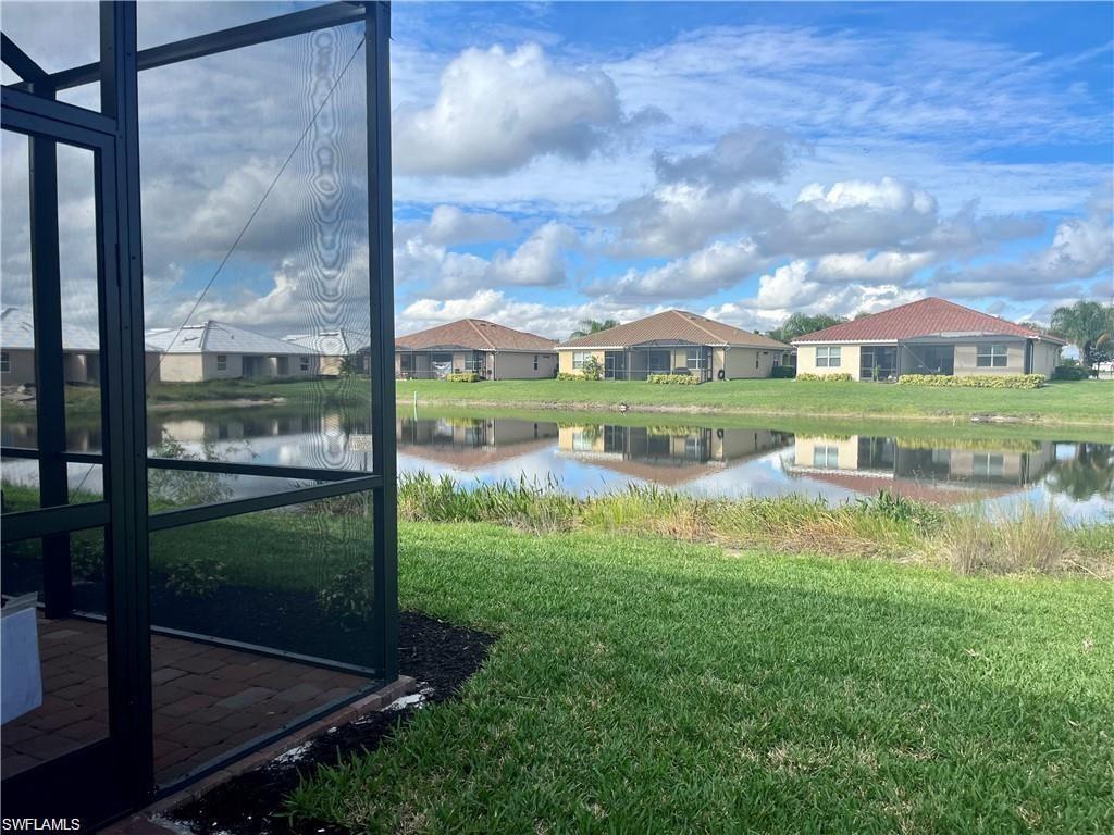 2057 Tamarron Lane Naples, FL 34120 - Photo 18 of 27 a view of a lake with a big yard