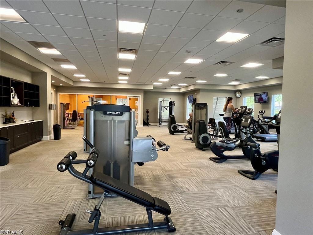 2057 Tamarron Lane Naples, FL 34120 - Photo 21 of 27 a view of a room with gym equipment