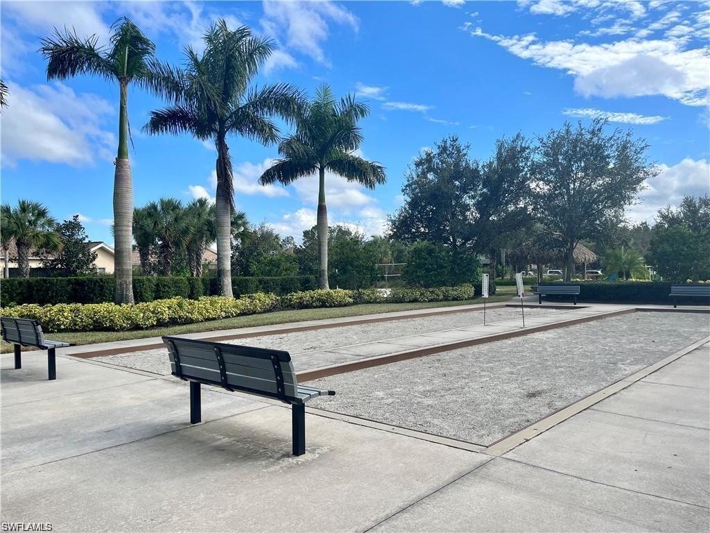 2057 Tamarron Lane Naples, FL 34120 - Photo 25 of 27 a view of a terrace with couches and wooden fence