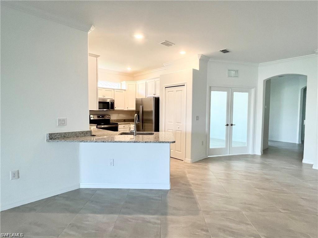 2057 Tamarron Lane Naples, FL 34120 - Photo 3 of 27 a view of kitchen and kitchen with granite countertop