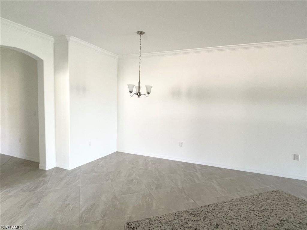 2057 Tamarron Lane Naples, FL 34120 - Photo 5 of 27 a view of empty room with floor to ceiling window