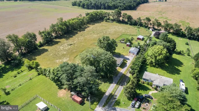 an aerial view of ocean with residential house with outdoor space