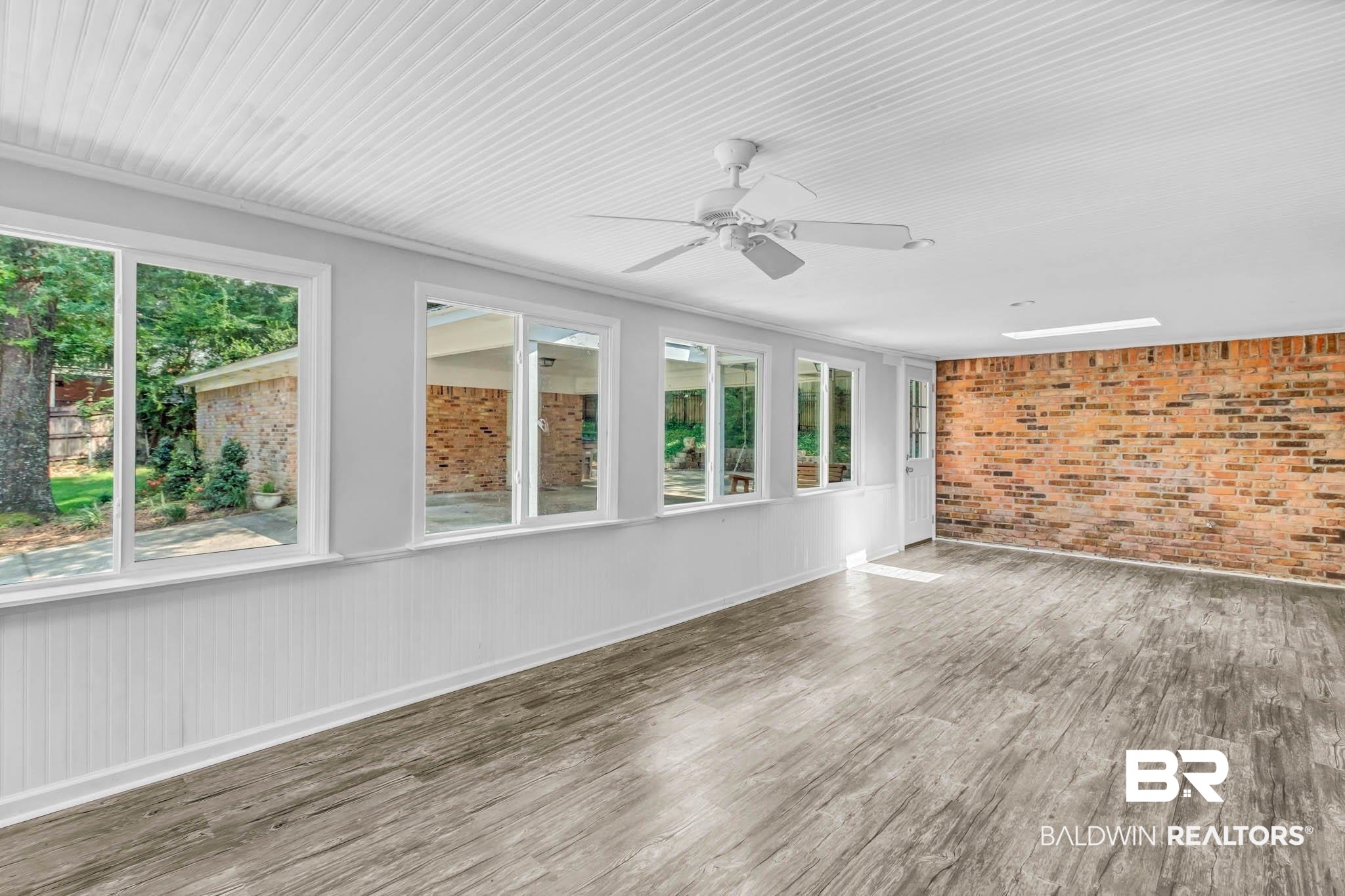 309 West Brandy Run Road Mobile, AL 36608 - Photo 74 of 100 Unfurnished sunroom with brick wall and wood finished floors
