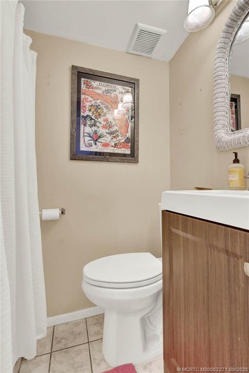 10701 South Ocean Drive, Unit 713 Jensen Beach, FL 34957 - Photo 17 of 39 a white toilet sitting next to a bathroom sink