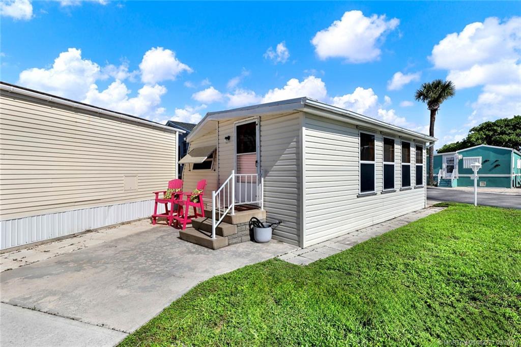 10701 South Ocean Drive, Unit 713 Jensen Beach, FL 34957 - Photo 20 of 39 a backyard of a house with table and chairs