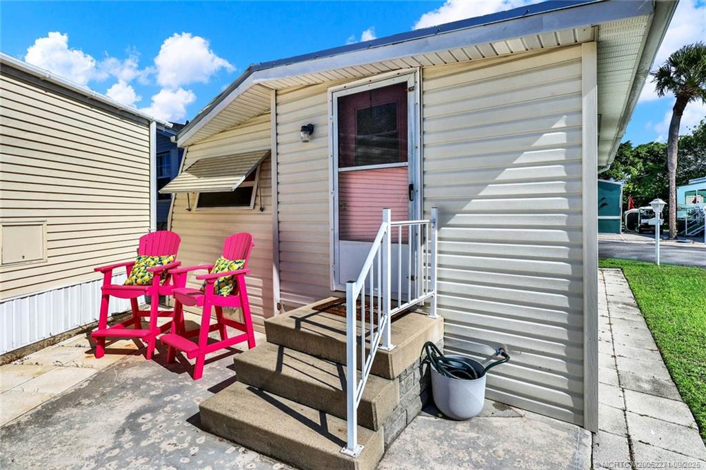 10701 South Ocean Drive, Unit 713 Jensen Beach, FL 34957 - Photo 21 of 39 a view of a patio with a dining table and chairs