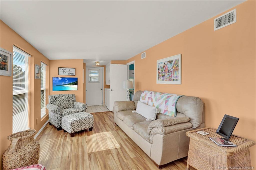 10701 South Ocean Drive, Unit 713 Jensen Beach, FL 34957 - Photo 4 of 39 a living room with furniture and wooden floor