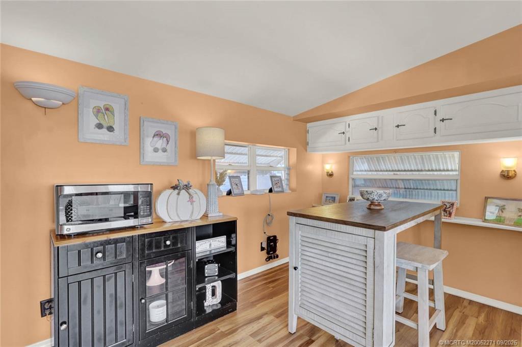 10701 South Ocean Drive, Unit 713 Jensen Beach, FL 34957 - Photo 6 of 39 a room with furniture a chandelier and a flat screen tv