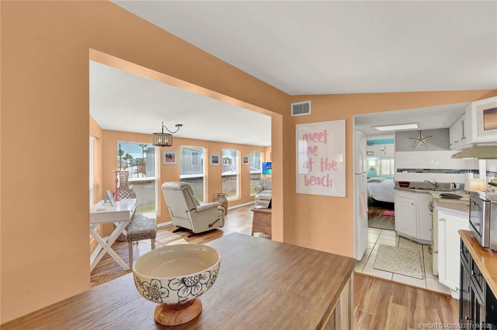 10701 South Ocean Drive, Unit 713 Jensen Beach, FL 34957 - Photo 7 of 39 a living room with furniture a table and kitchen view