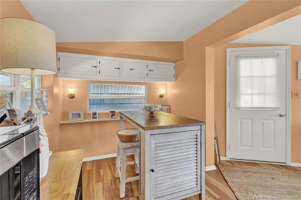 10701 South Ocean Drive, Unit 713 Jensen Beach, FL 34957 - Photo 8 of 39 a kitchen with stainless steel appliances granite countertop a sink and cabinets