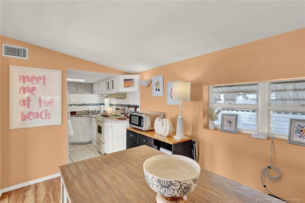 10701 South Ocean Drive, Unit 713 Jensen Beach, FL 34957 - Photo 9 of 39 a kitchen with a refrigerator and a stove