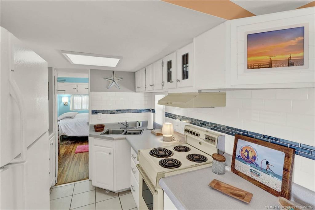 10701 South Ocean Drive, Unit 713 Jensen Beach, FL 34957 - Photo 10 of 39 a kitchen with a stove and a sink