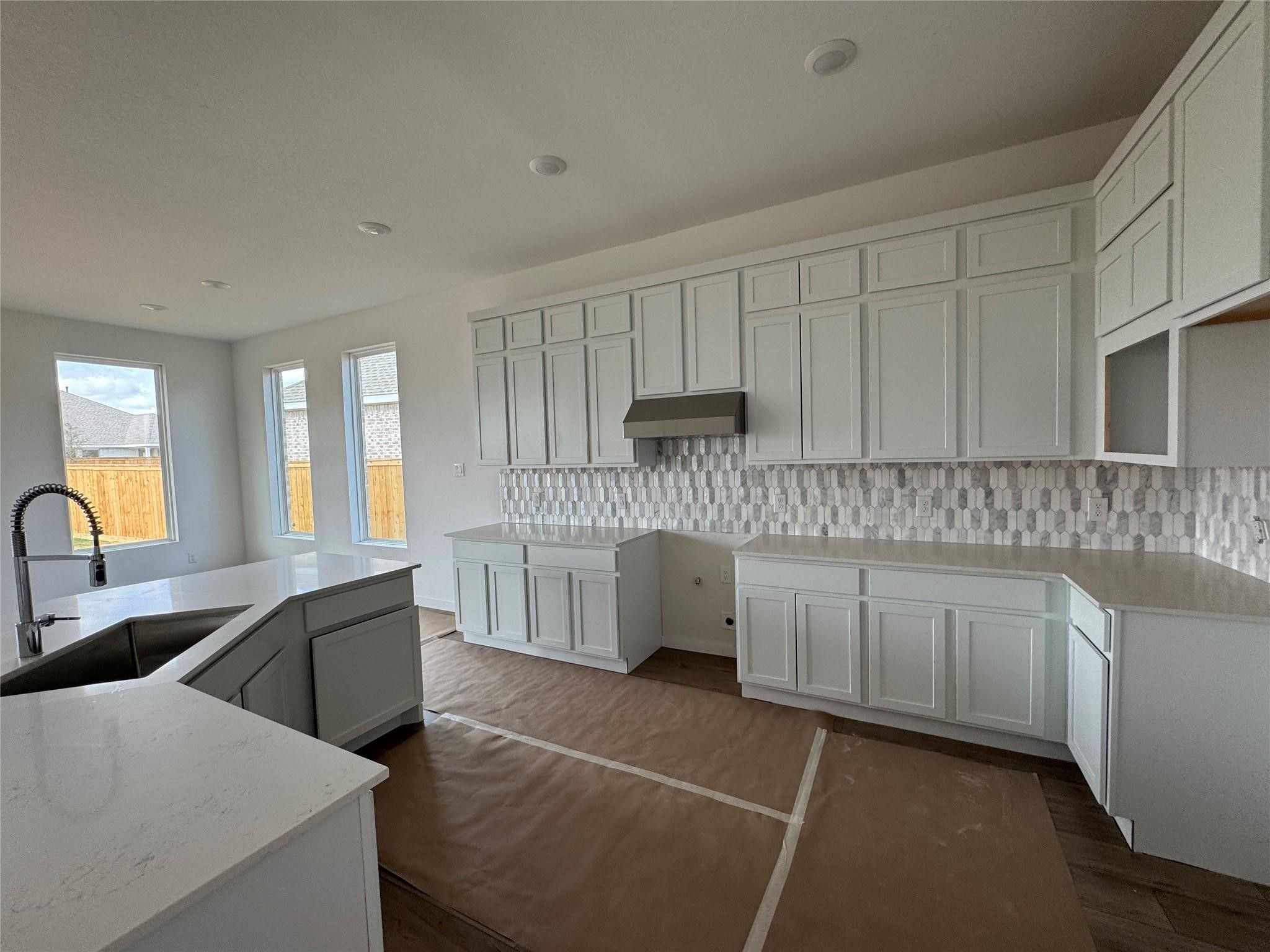 8222 Holly Blue Drive Rosharon, TX 77583 - Photo 21 of 23 a kitchen with cabinets a sink and dishwasher a stove top oven with wooden floor