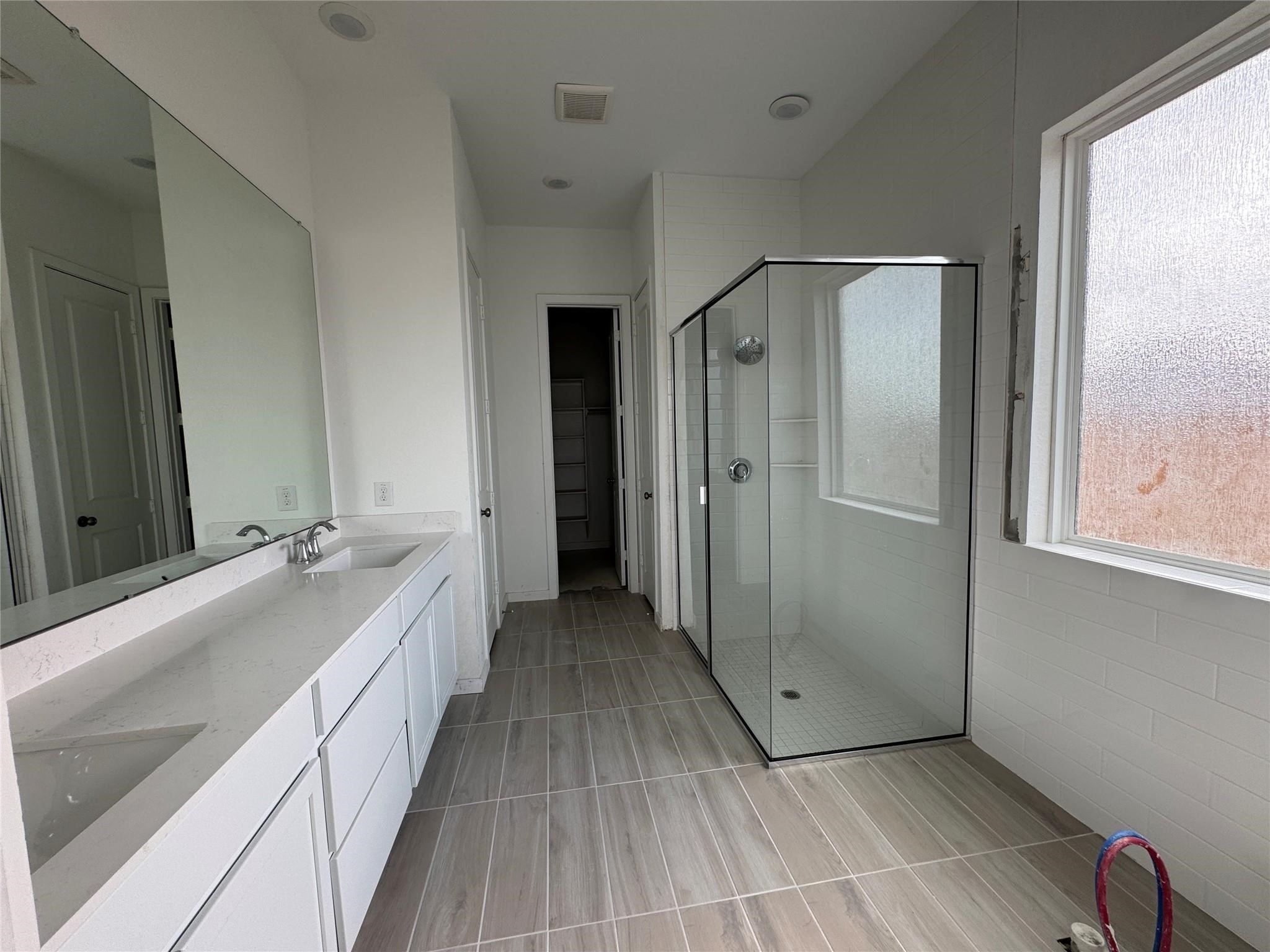 8222 Holly Blue Drive Rosharon, TX 77583 - Photo 22 of 23 a spacious bathroom with a granite countertop sink mirror and a bathtub