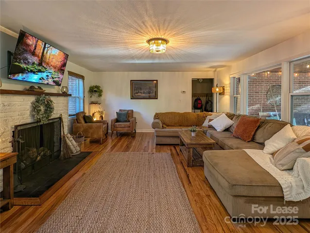 a living room with furniture a flat screen tv and a fireplace
