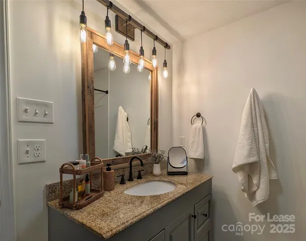 a bathroom with double vanity and a mirror