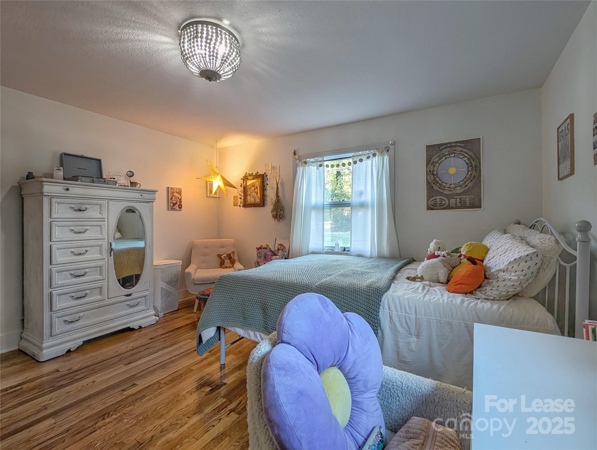 317 Balsam Drive Waynesville, NC 28786 - Photo 20 of 45 a bedroom with bed and a window