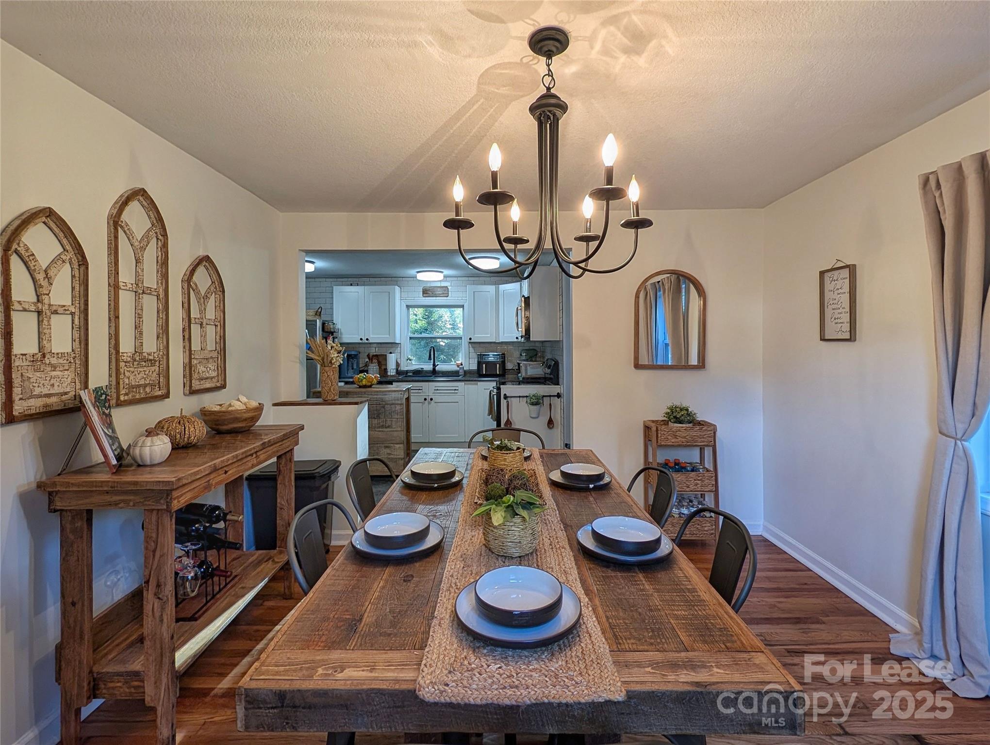 317 Balsam Drive Waynesville, NC 28786 - Photo 21 of 45 a view of a dining room with furniture and a chandelier