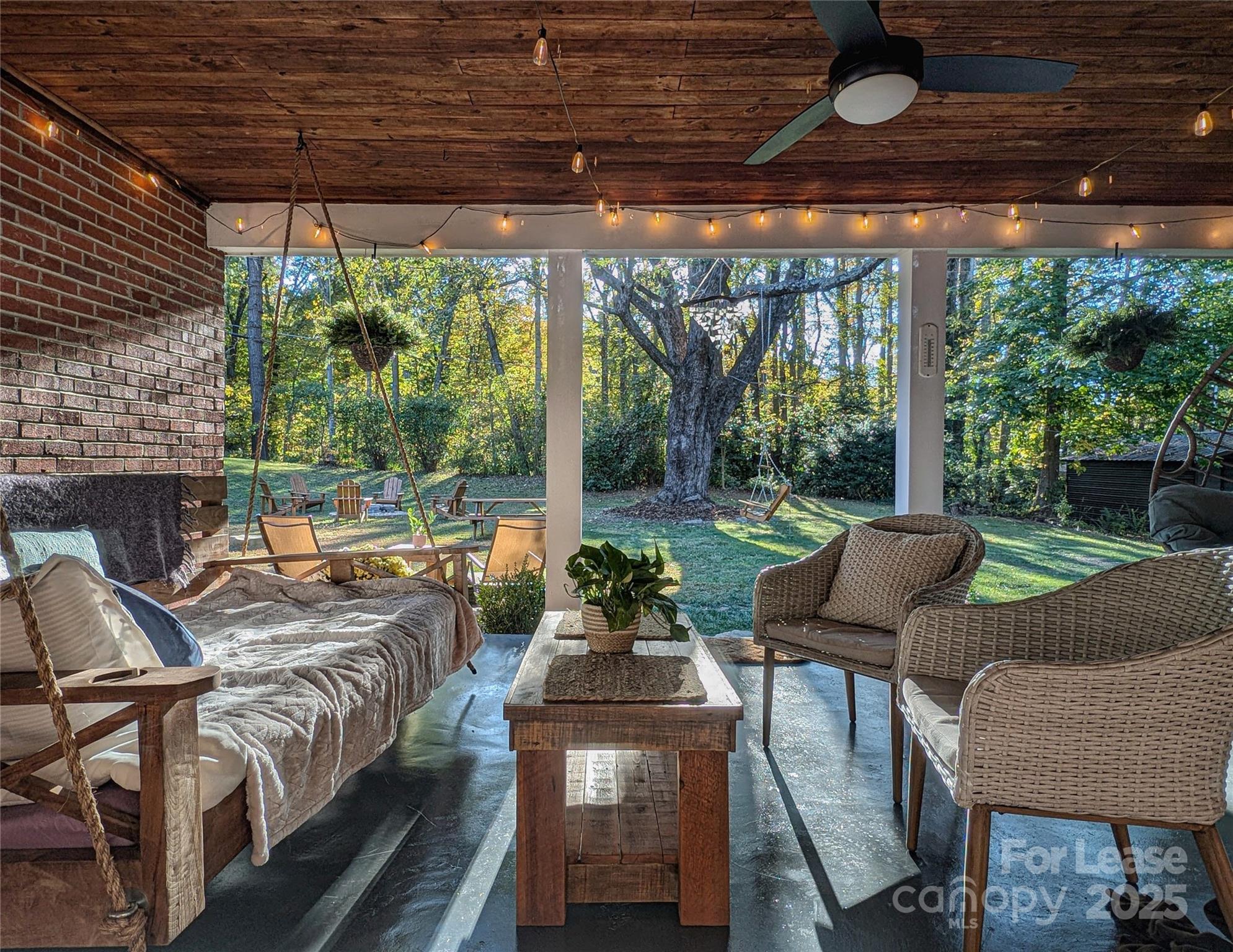 317 Balsam Drive Waynesville, NC 28786 - Photo 22 of 45 a outdoor space with patio the couches and a dining table with garden view