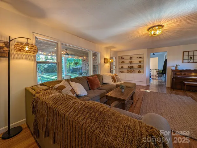 a large bedroom with a bed and wooden floor